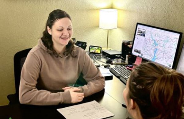 personalized-care A patient sitting at a desk talking to a provider
